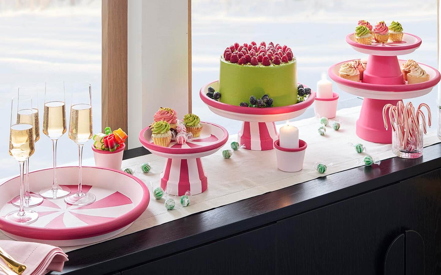 Cake and dessert stands filled with treats on a holiday table.