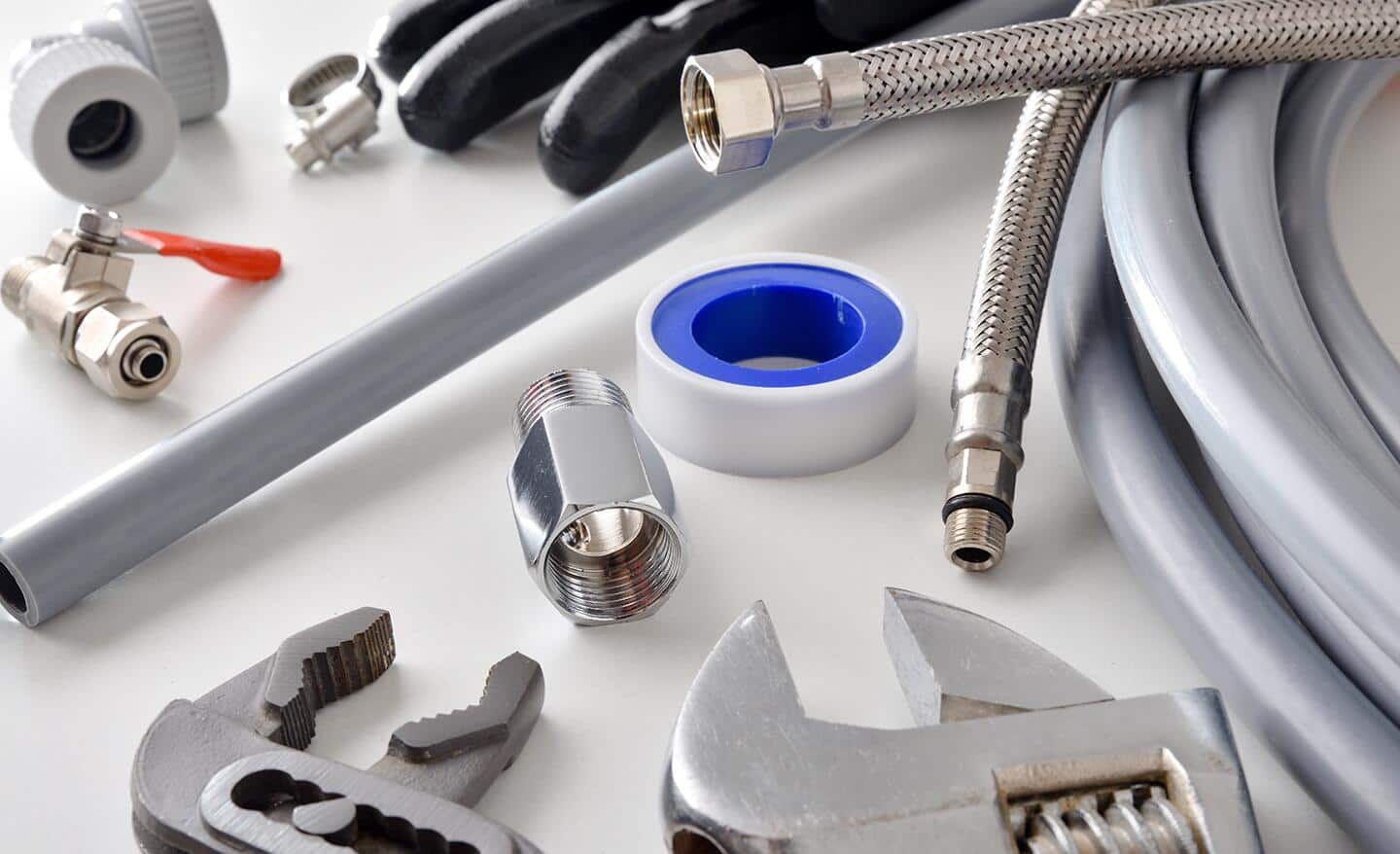 Wrenches, galvanized steel tubing and other materials for installing a refrigerator water line.