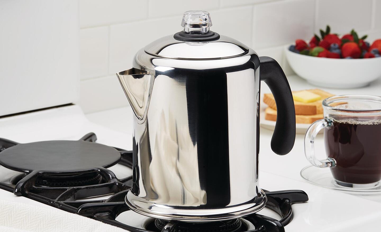 A percolator coffee maker on a stovetop. A percolator coffee maker on a stovetop.