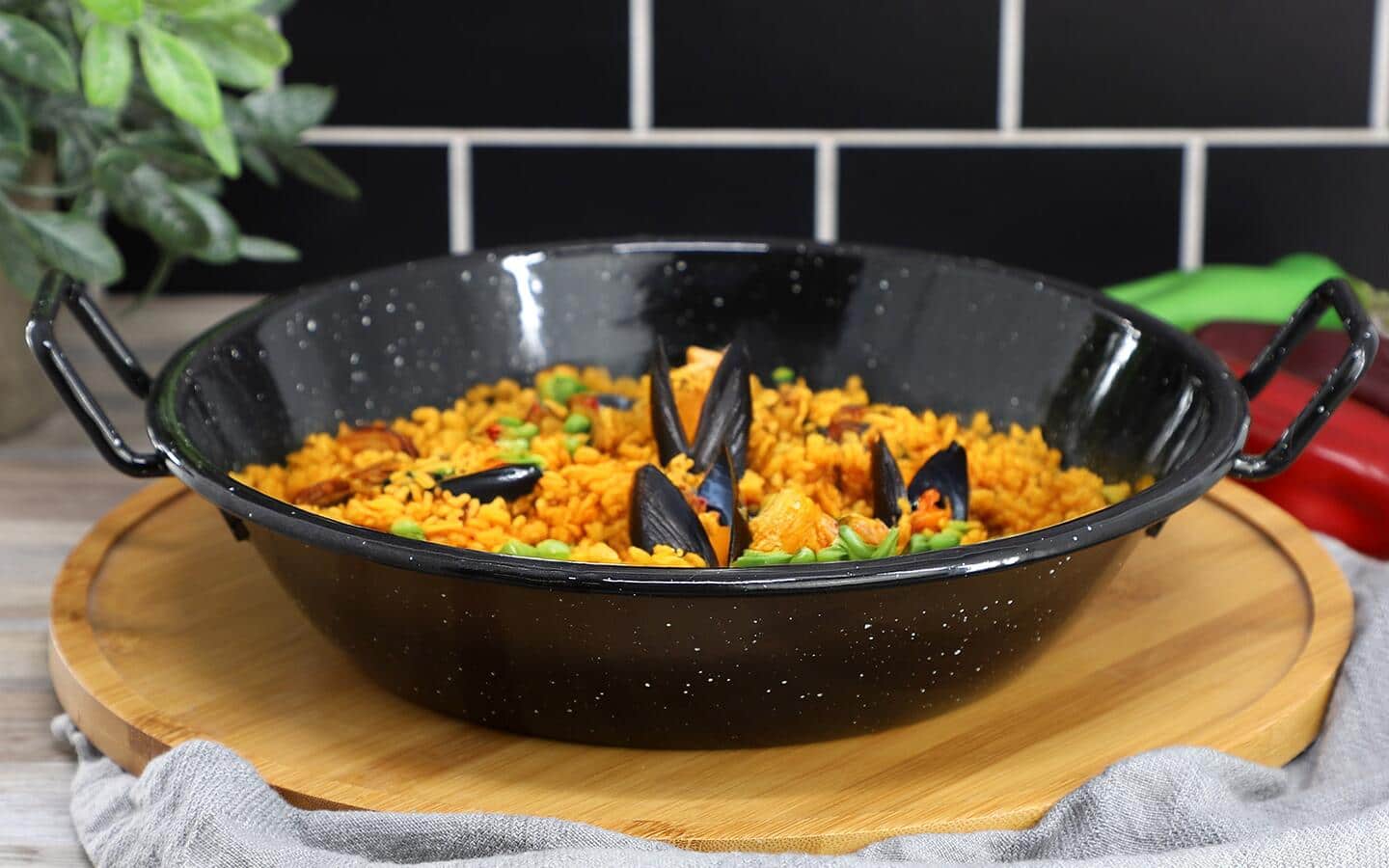 Food in a wok on a round wooden serving tray. Food in a wok on a round wooden serving tray.