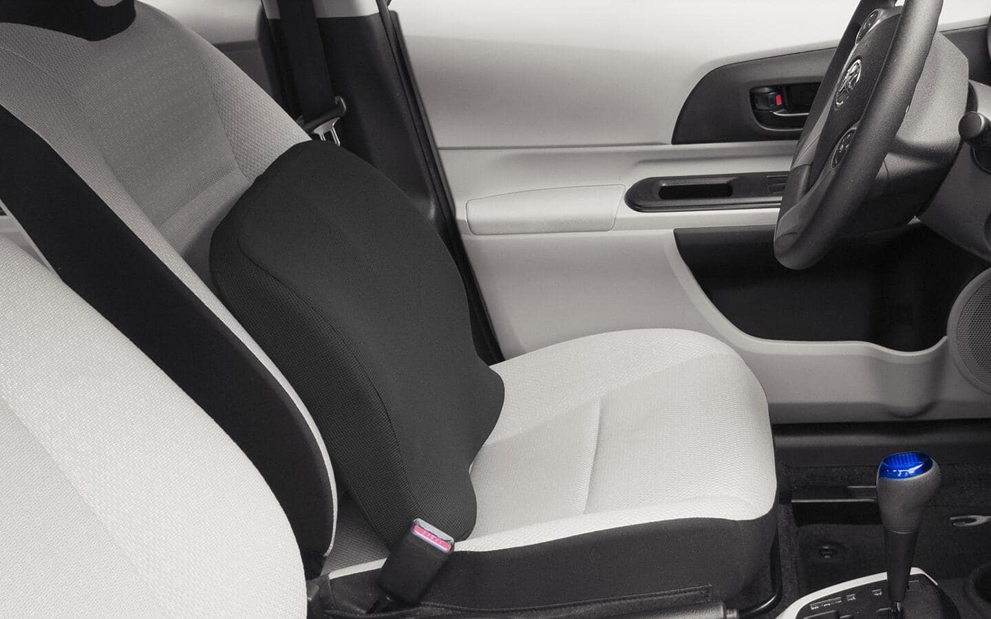 A lumbar support pillow in the driver's seat of a car. A lumbar support pillow in the driver's seat of a car.
