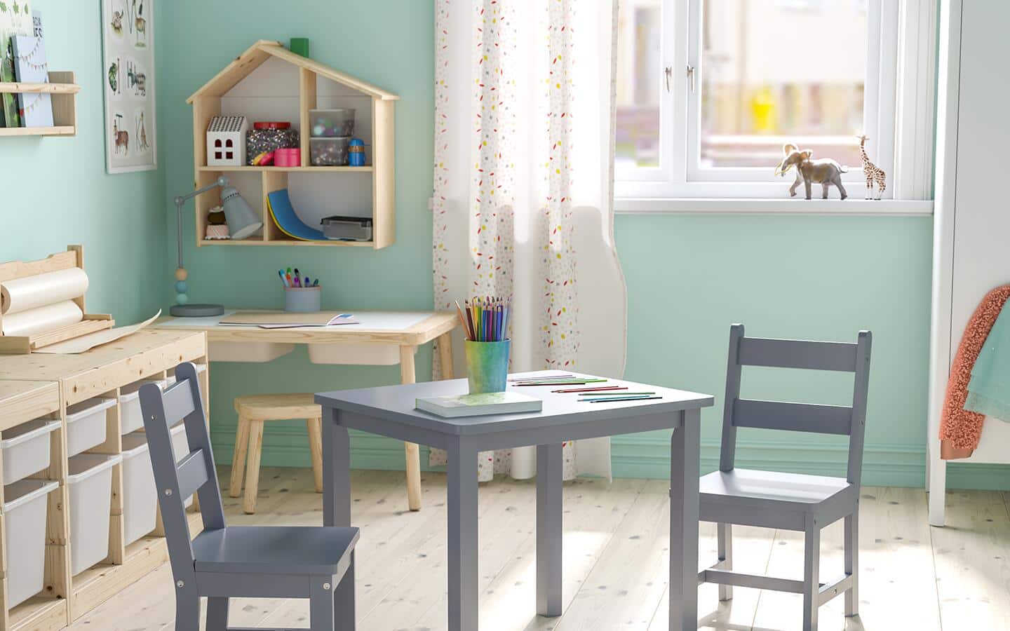 A playroom with pastel green paint on the walls