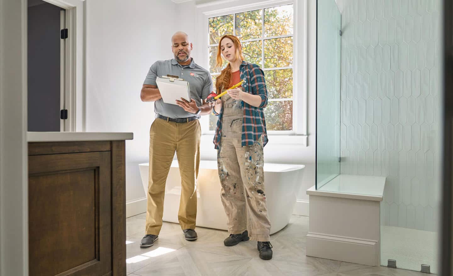 A contractor and their supervisor reviewing their client's remodeling needs