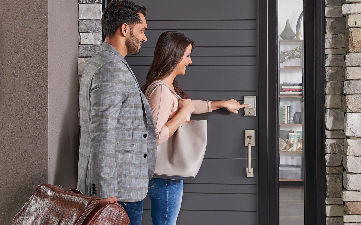 Couple returning home and using a smart keypad on their front door to get in. Couple returning home and using a smart keypad on their front door to get in.