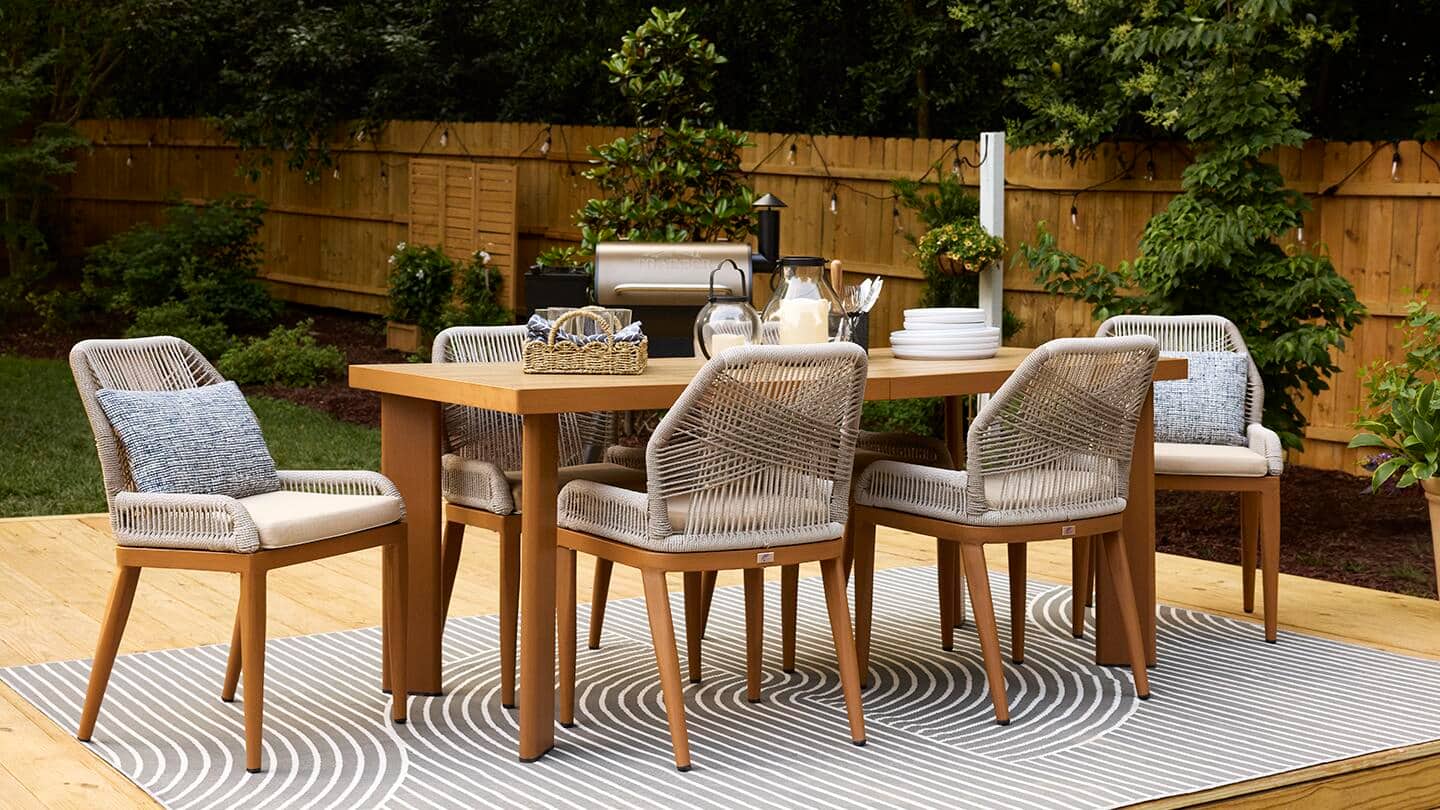 An outdoor dining table and chairs on a patio in springtime