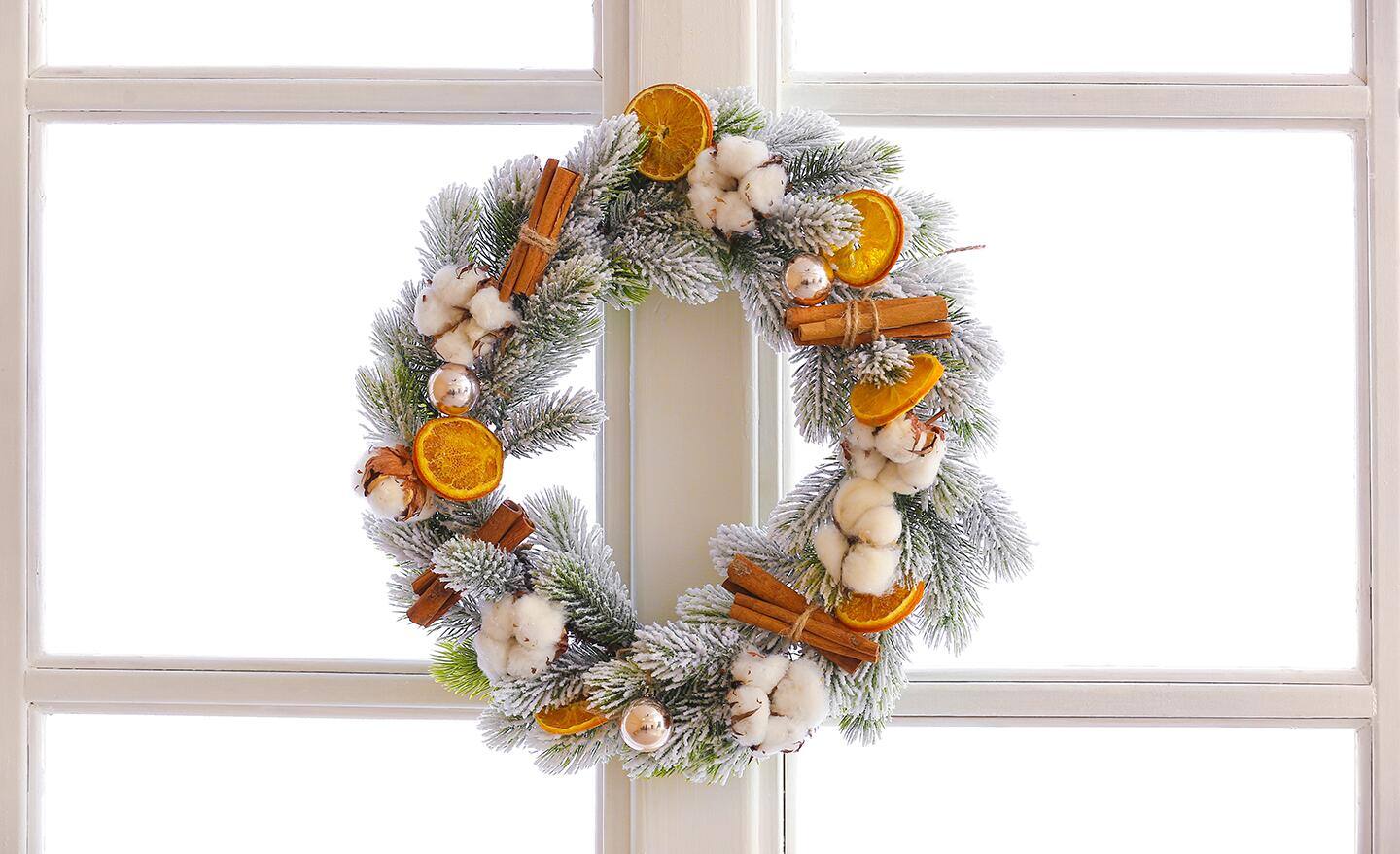 A fruit wreath with faux snow on it. A fruit wreath with faux snow on it.