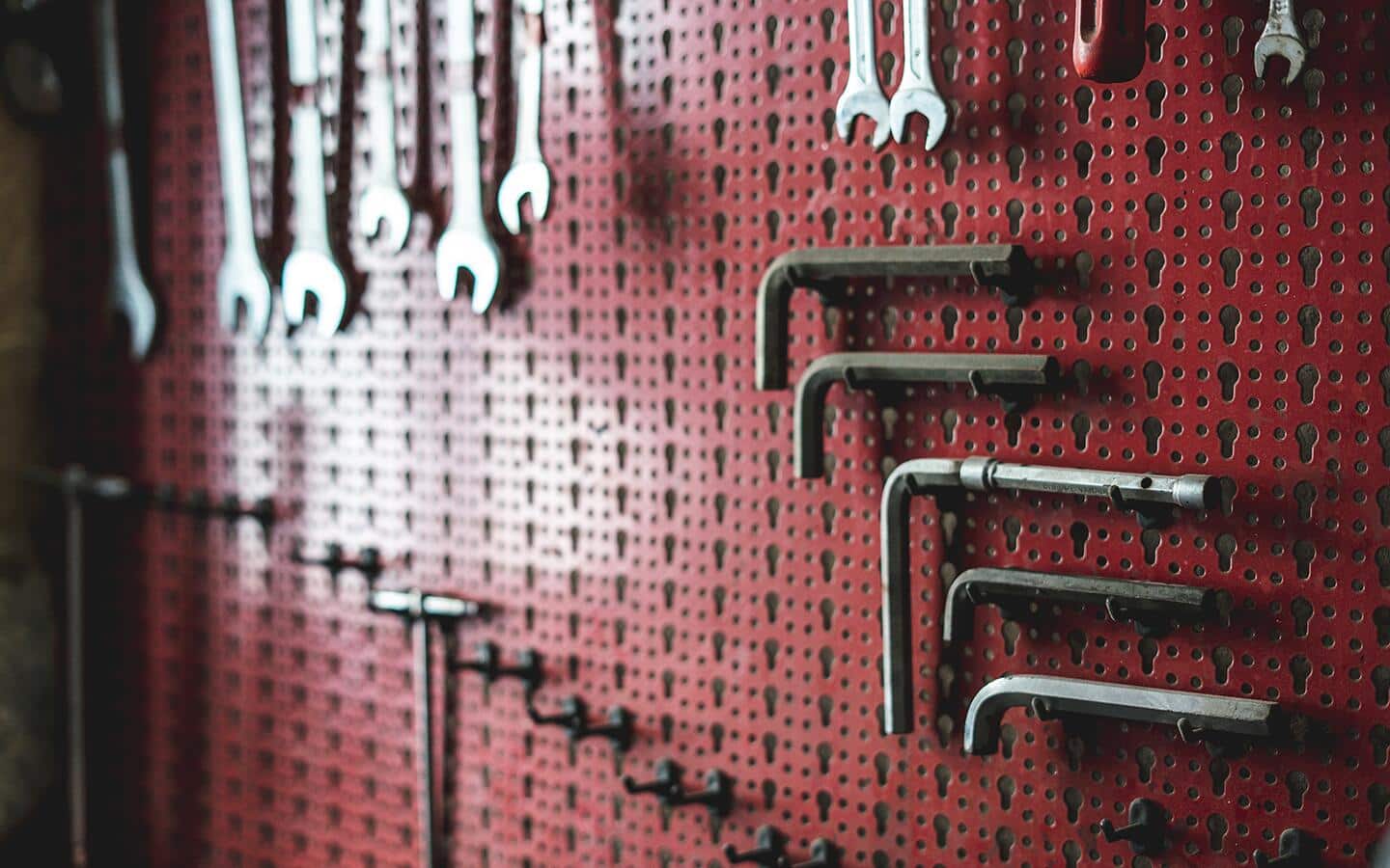 Tools on a pegboard in a garage. 