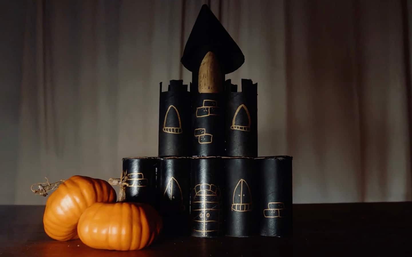 A completed haunted castle with pumpkins on a table. A completed haunted castle with pumpkins on a table.