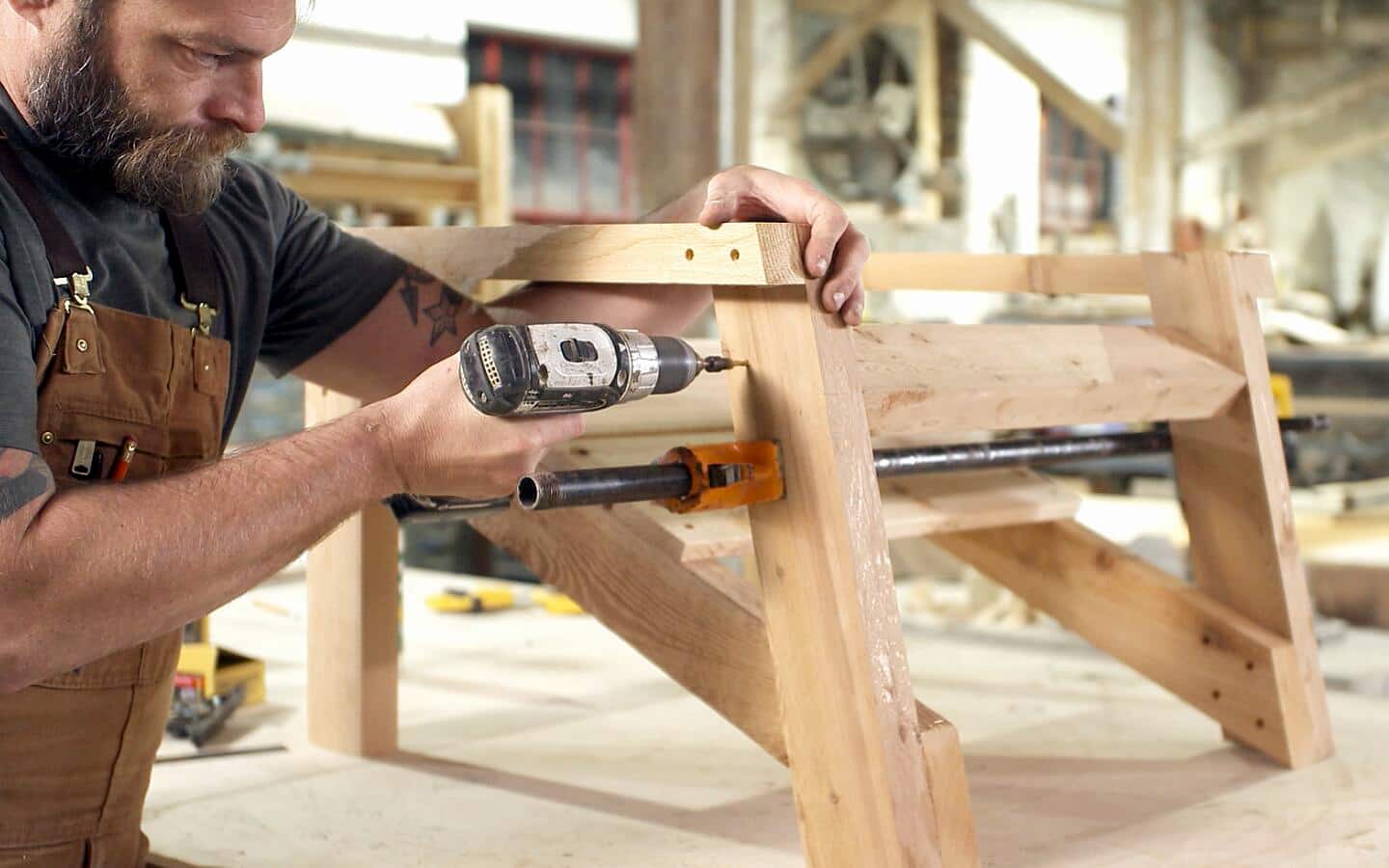 A person attaching the back support for an Adirondack chair. A person attaching the back support for an Adirondack chair.