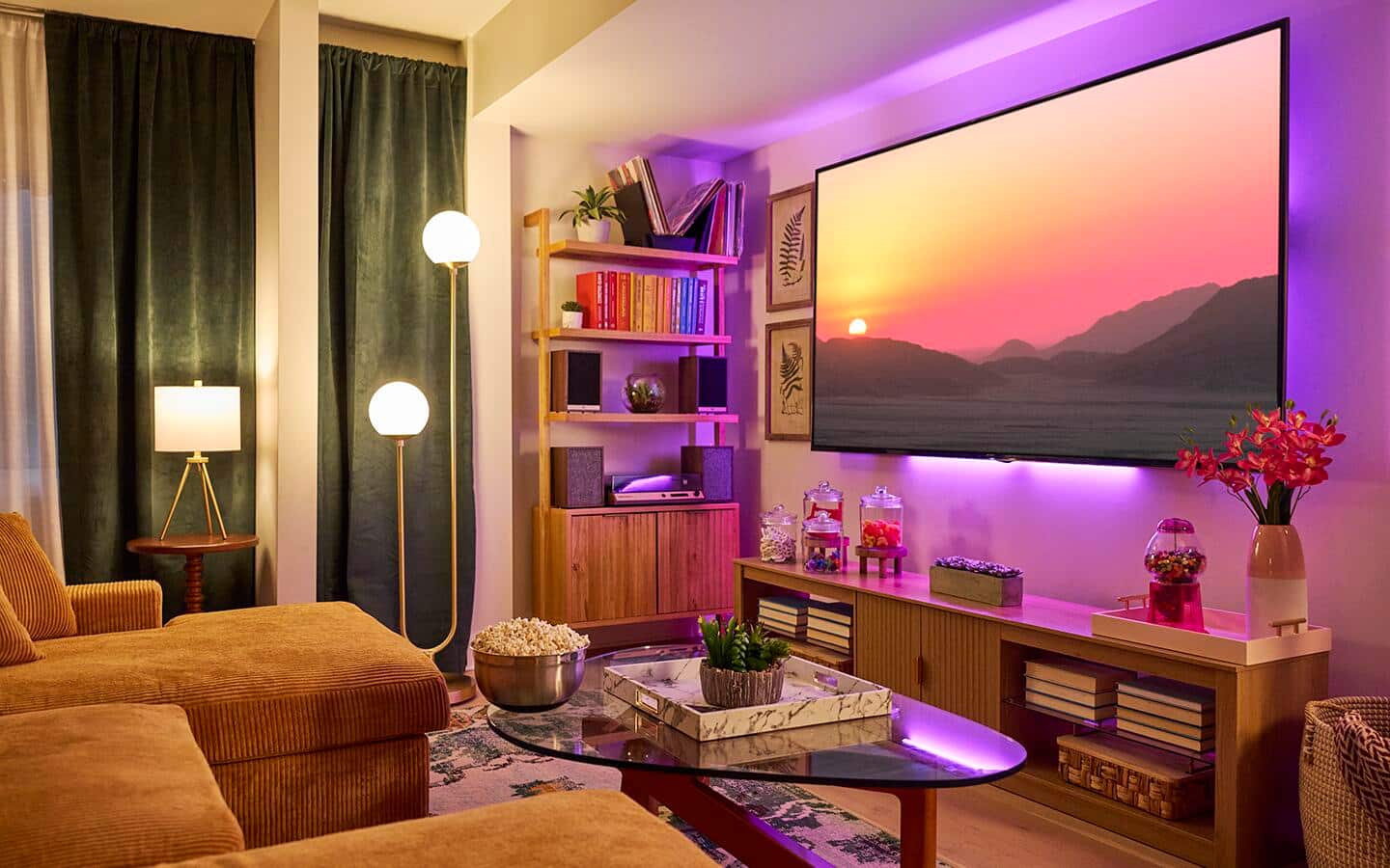 A small living room filled with a couch, coffee table and a wall-mounted TV. A small living room filled with a couch, coffee table and a wall-mounted TV.