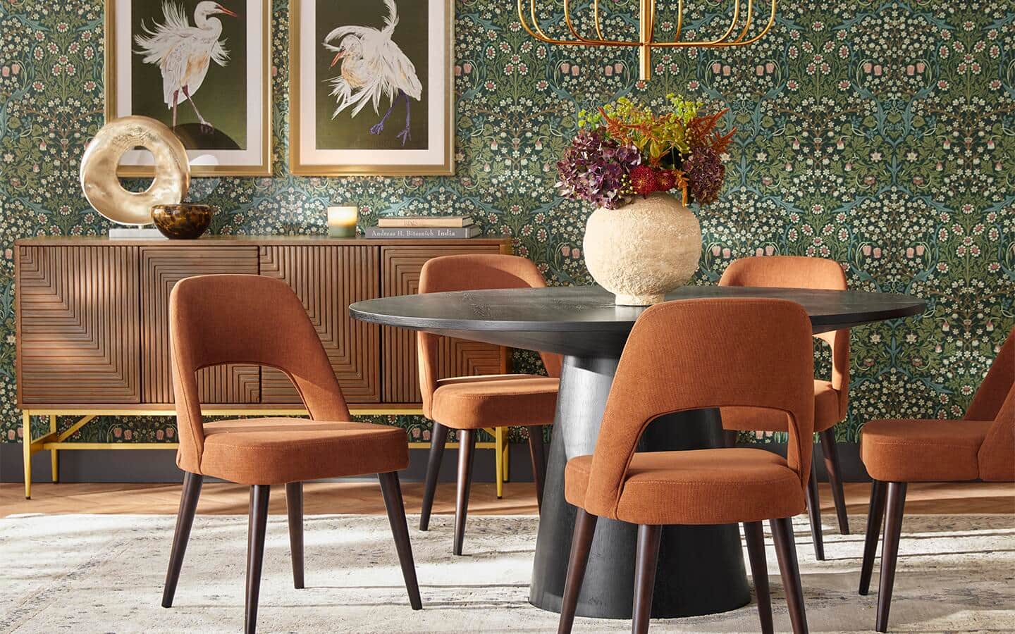 A colorful dining room of corals, greens and tans inspired by its wallpaper.
