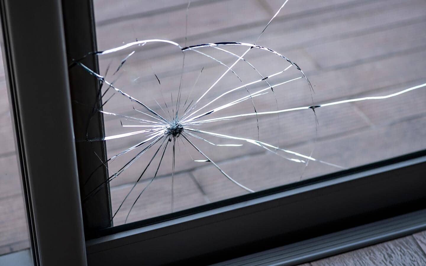 Glass breaking in the lower corner of a patio door.