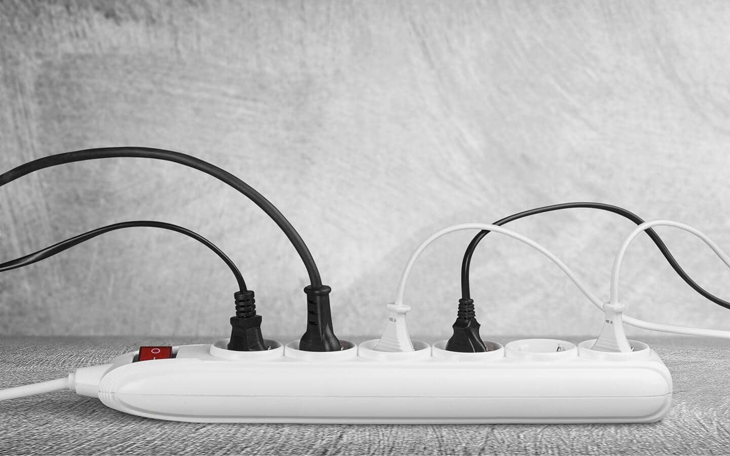 Christmas light cords plugged into a power strip. Christmas light cords plugged into a power strip.