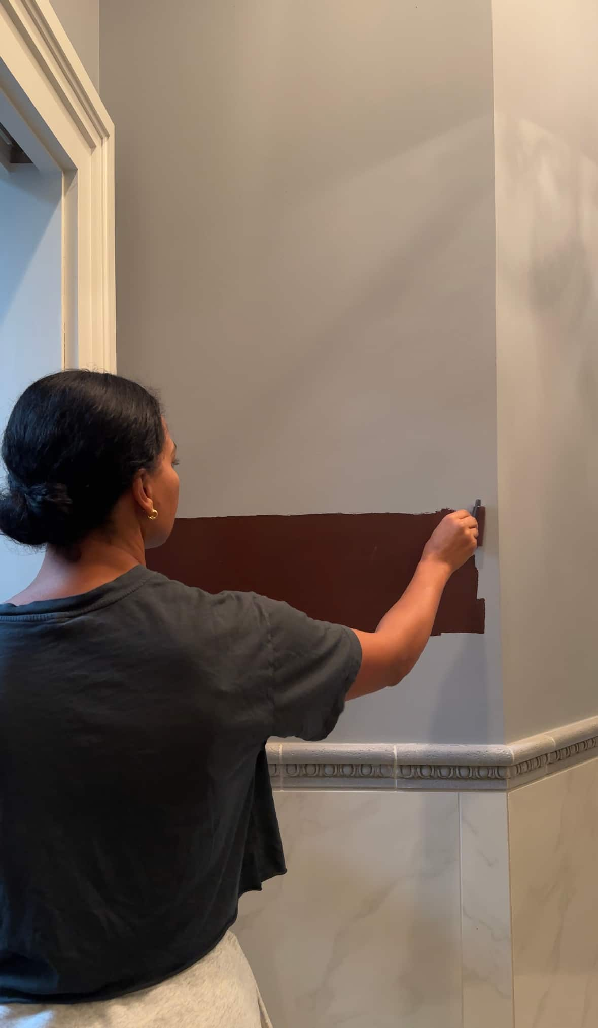 A person painting a wall.