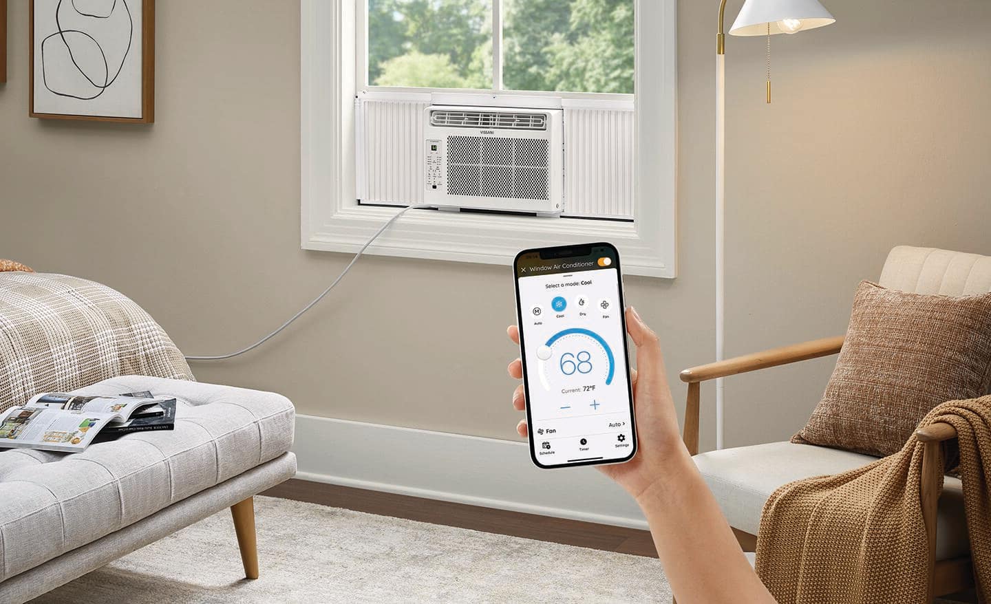Someone using a smartphone to regulate a bedroom's window air conditioner.