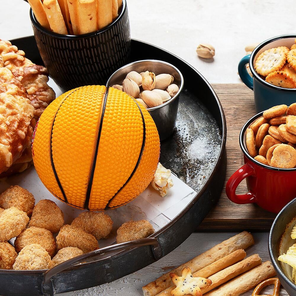 Basketball-inspired food spread of pretzels, crackers and other foods.