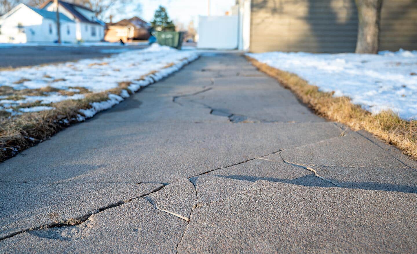 A sidewalk that has several cracks.