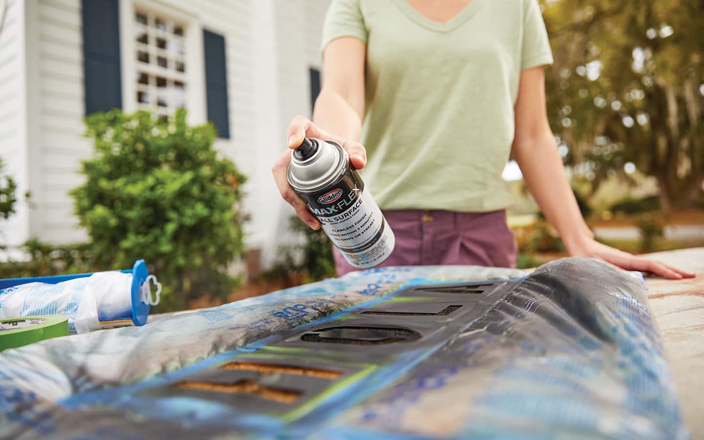 A person spray painting a stencil.