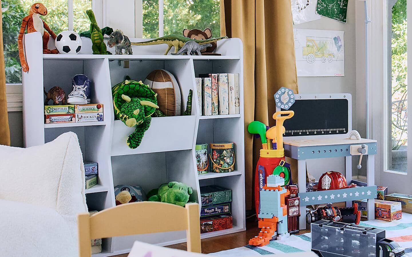 A playroom with an organized storage unit.