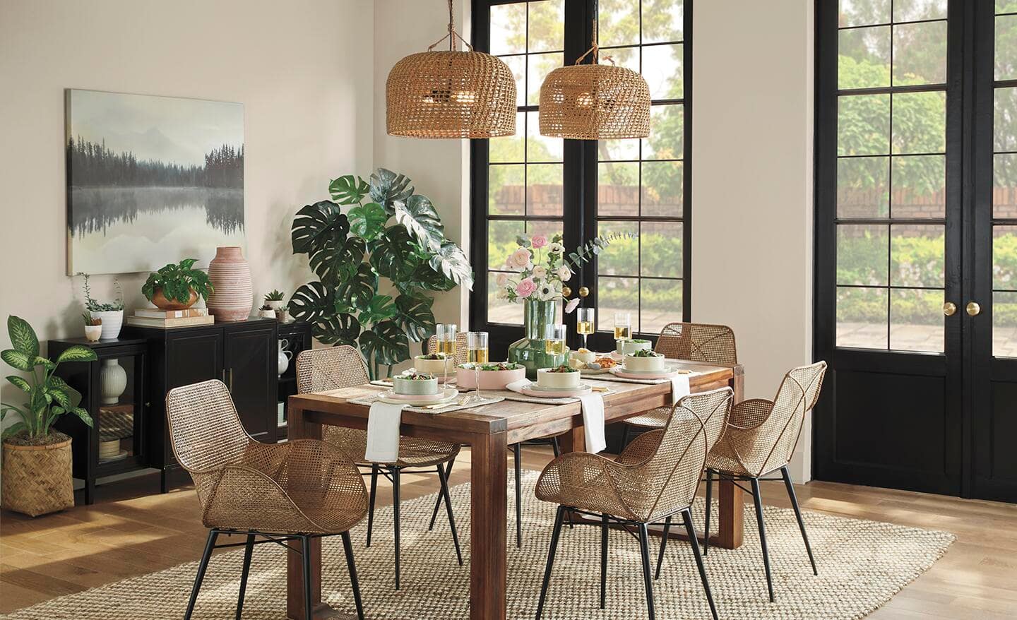 A casual dining room featuring pendants with basketweave shades and complementary chairs.
