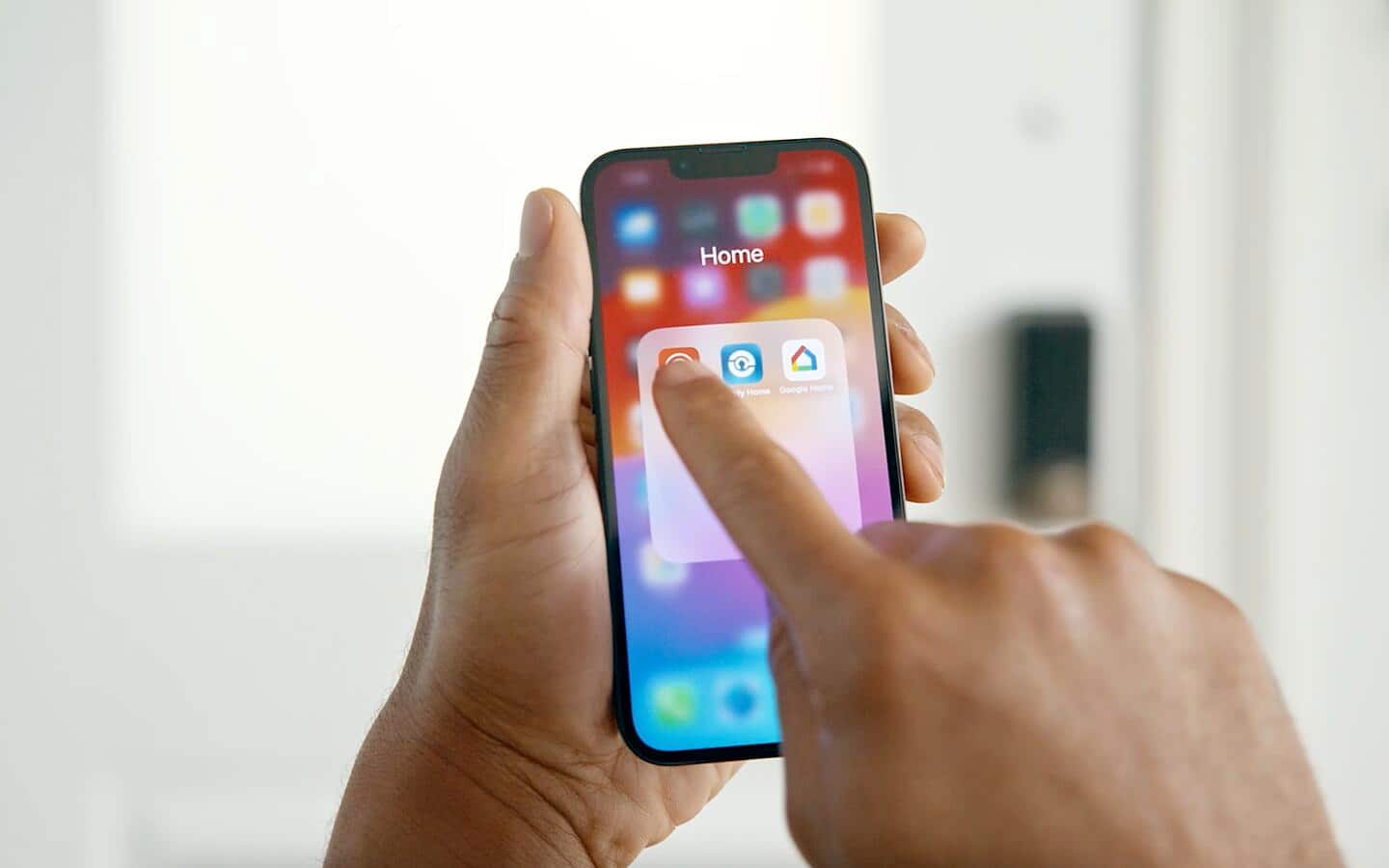 A person uses a smart phone to update software and control their smart system.