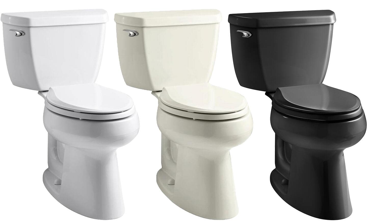 A white toilet, an almond toilet and a black toilet placed side-by-side.