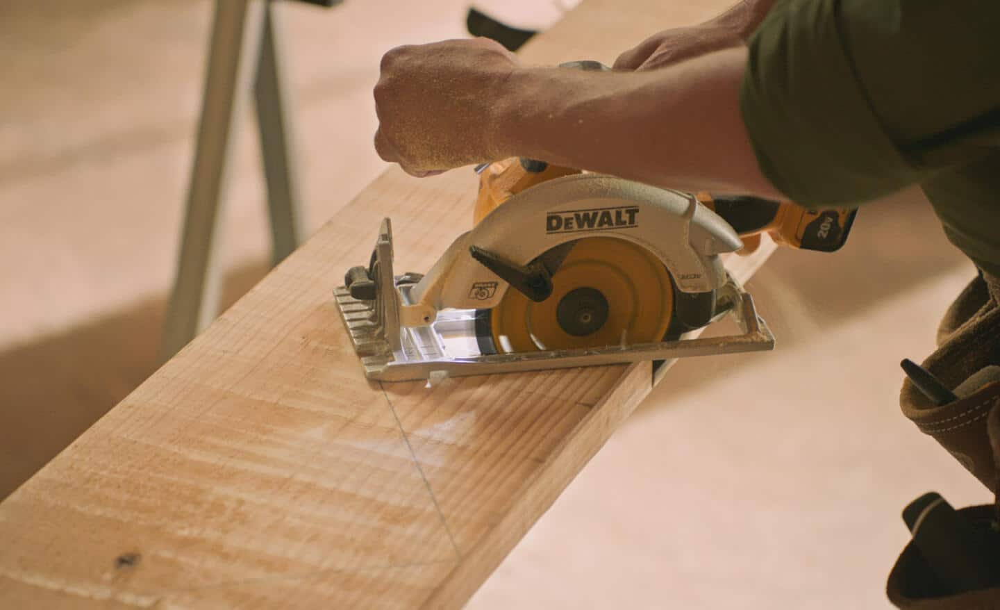 A Pro cuts a stair stringer with a circular saw.
