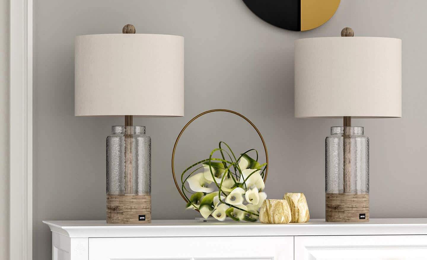 Two buffet lamps sit on a white dresser. 