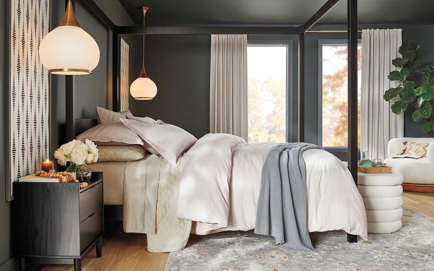 A bedroom sets a tranquil vibe with shades of taupe and beige with gray accents.