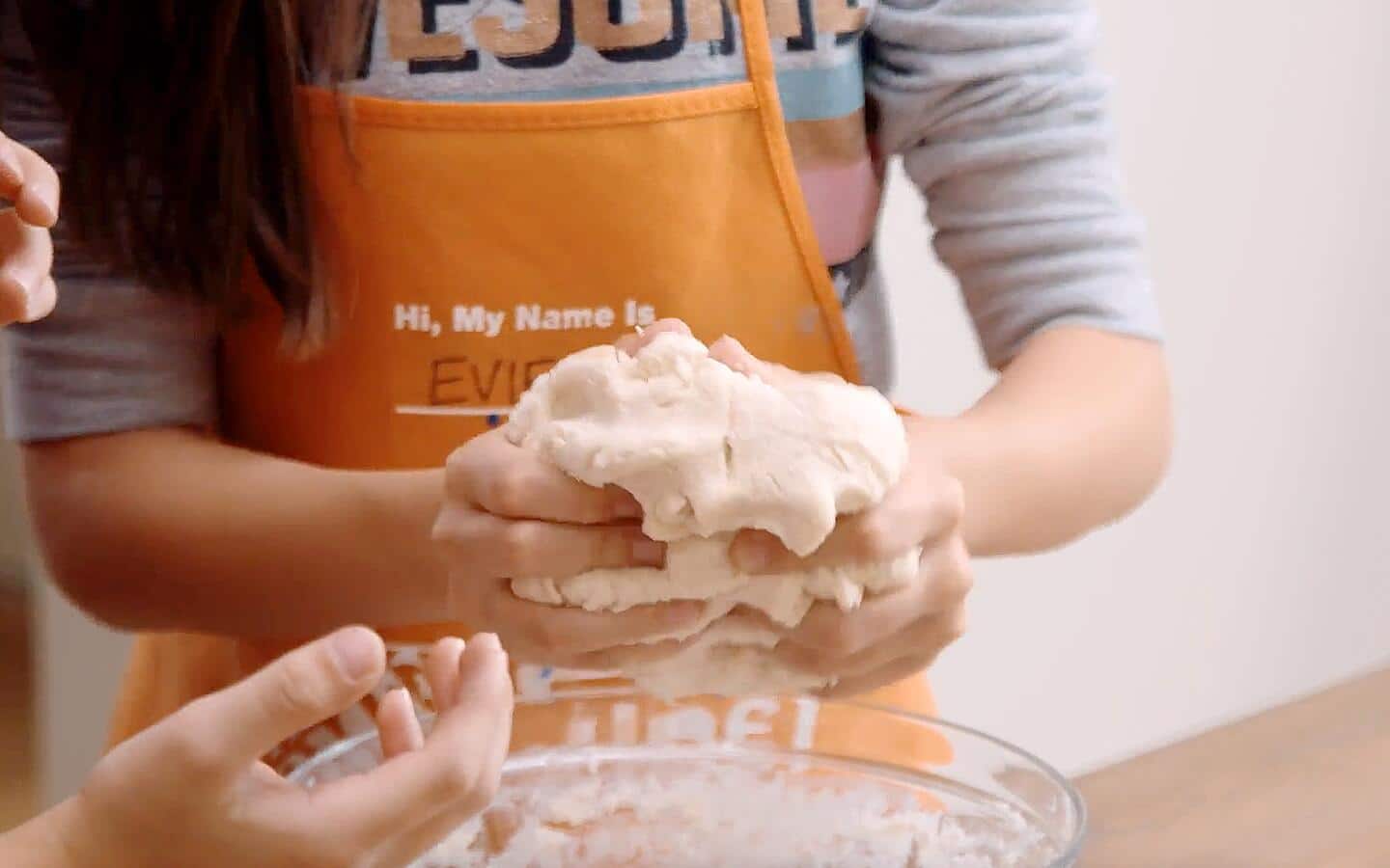 Someone kneading a fistful of salt dough.