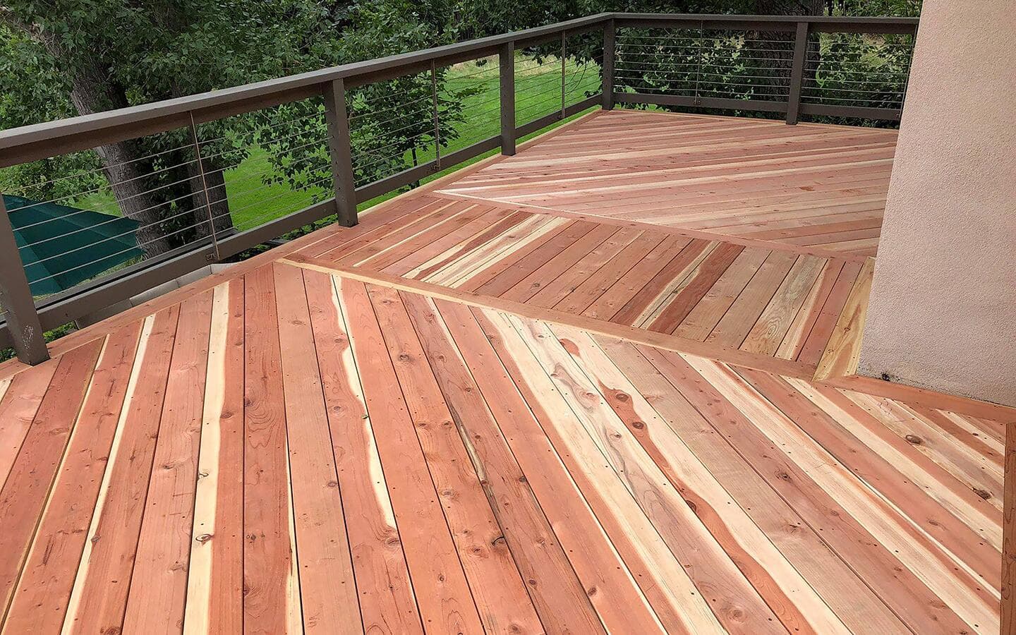 The corner of a deck made from redwood lumber.