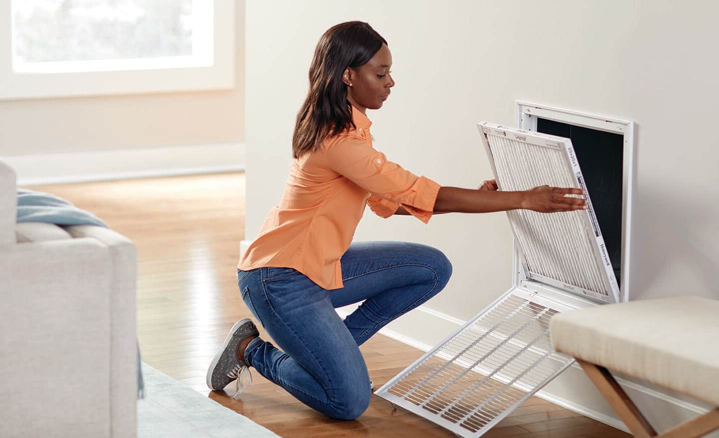 Homeowner changes air filter in her home Homeowner changes air filter in her home
