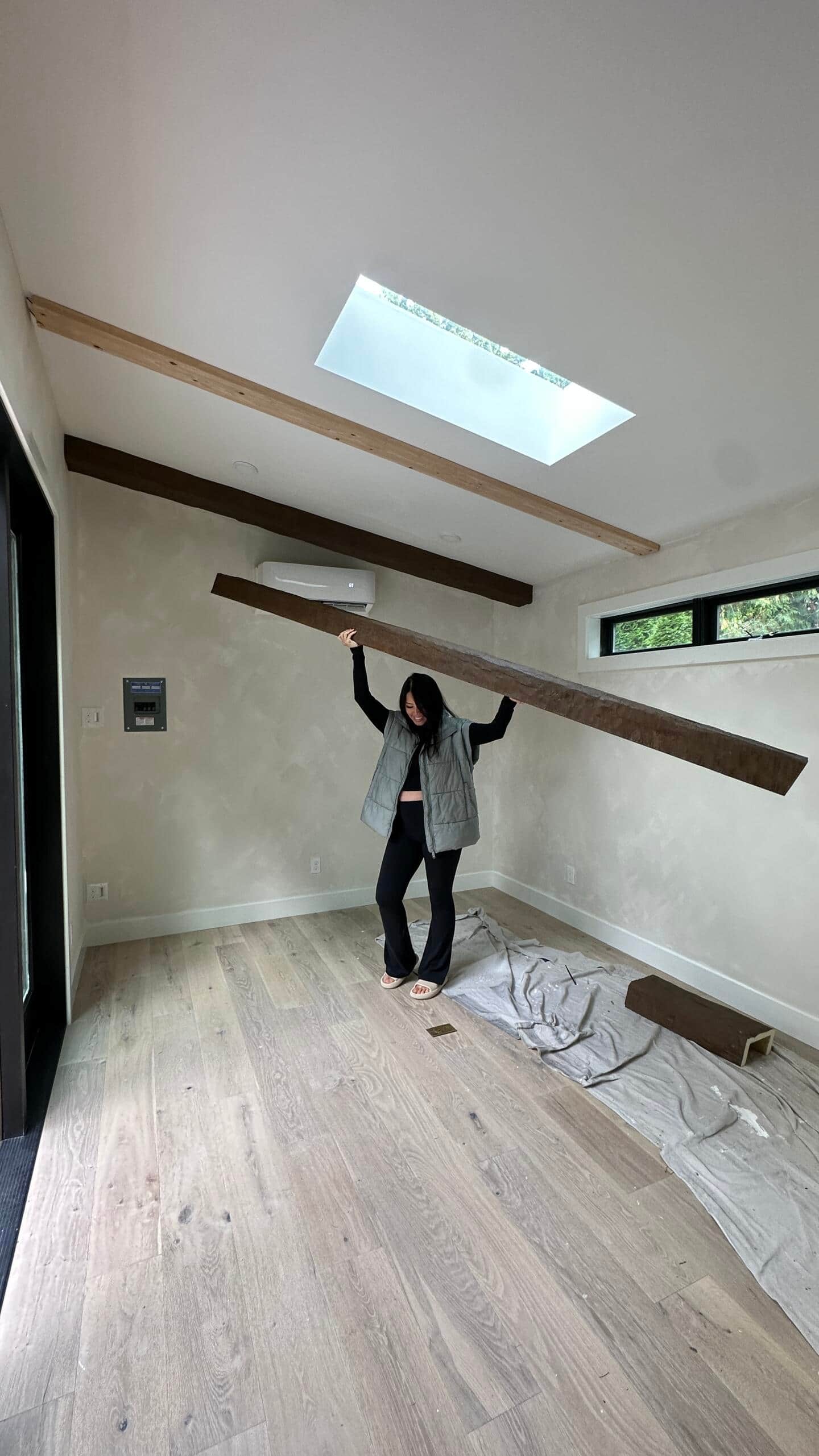 Mid project, Sabrina carrying a wood beam
