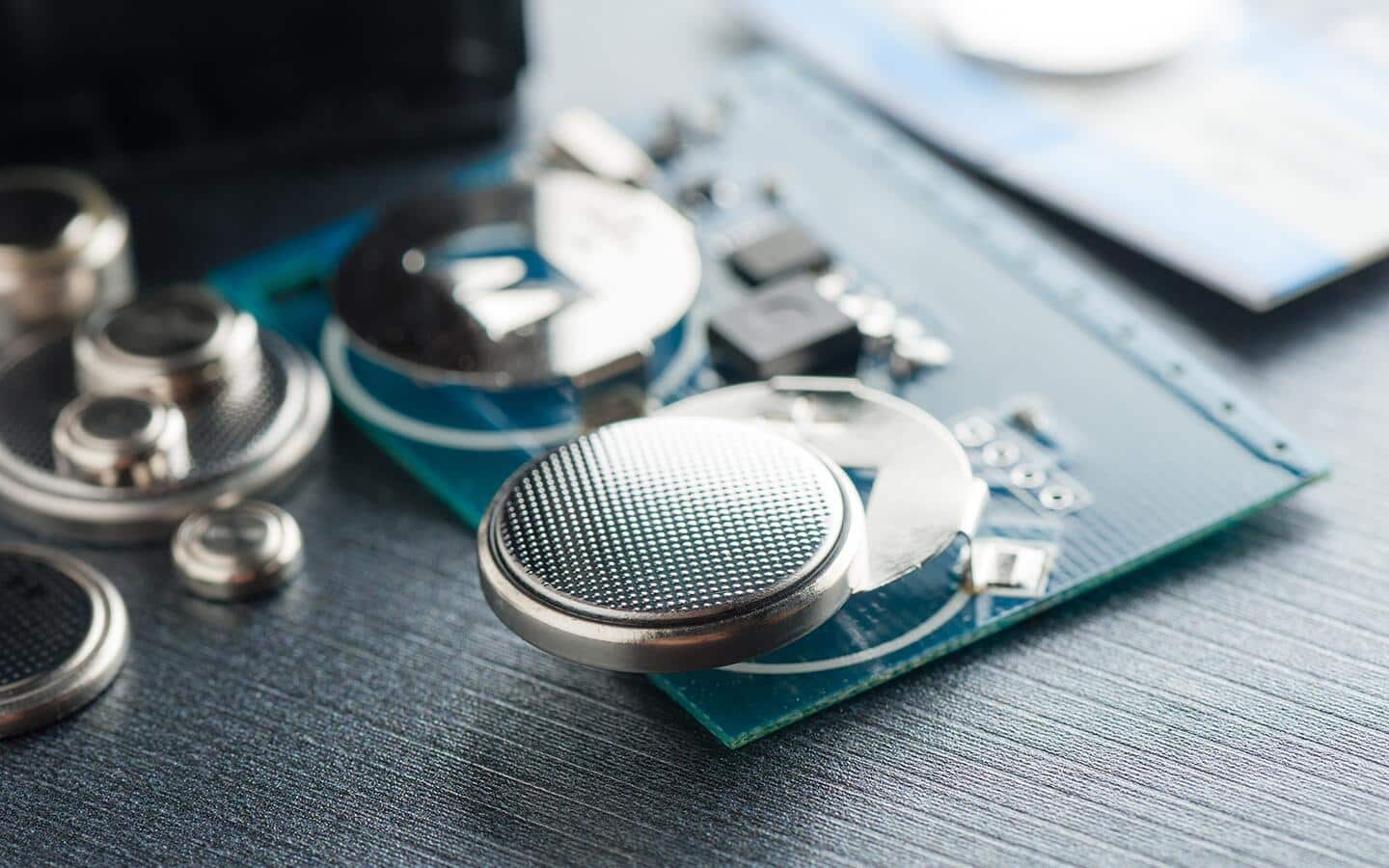 A coin cell battery inserted in a portable electronic device.