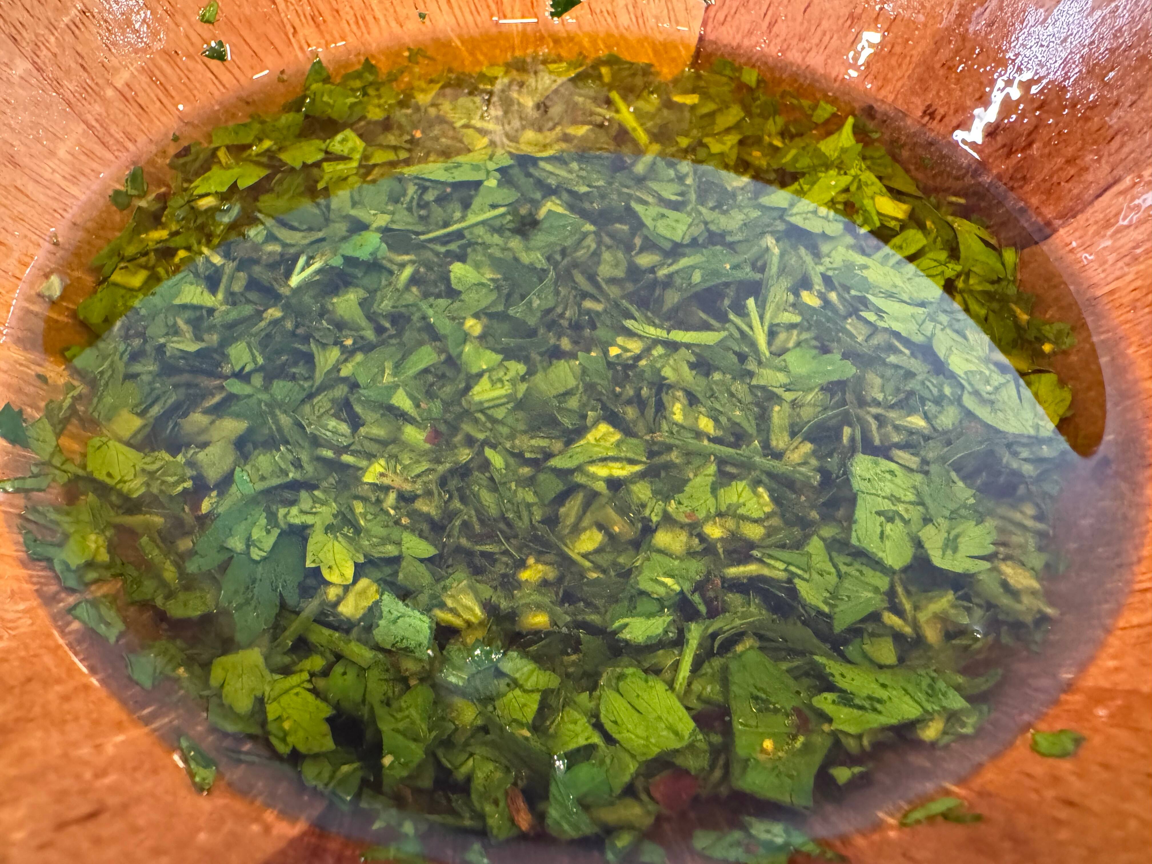 A bowl of chimichurri sauce. A bowl of chimichurri sauce.