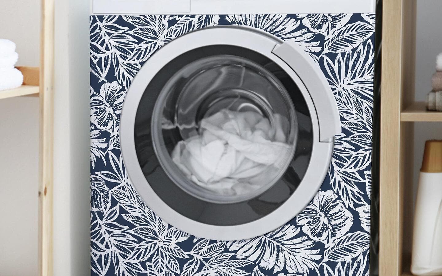 Geometric peel and stick wallpaper decorates the front of a washing machine. Geometric peel and stick wallpaper decorates the front of a washing machine.