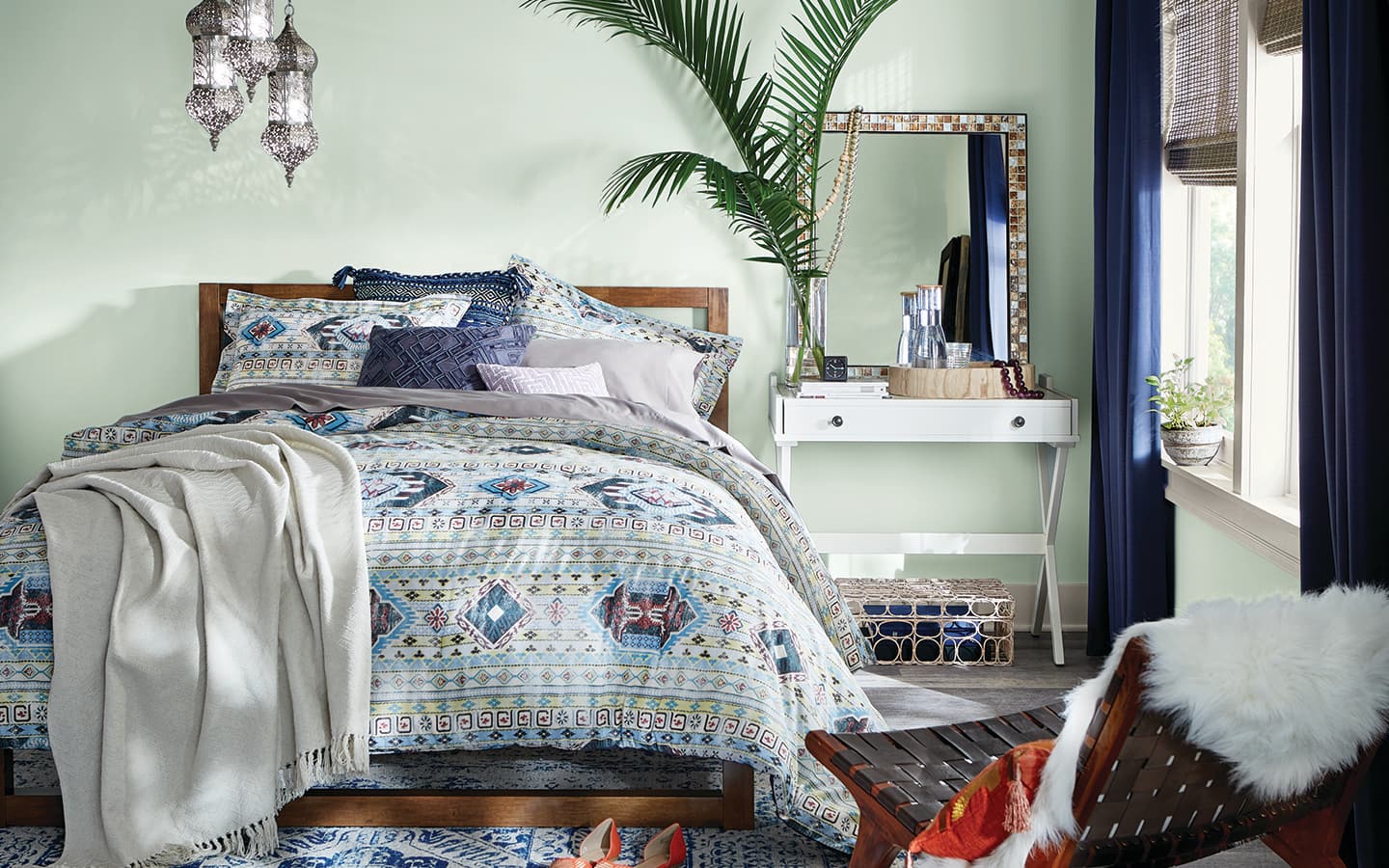A bedroom with greenery and a bold print