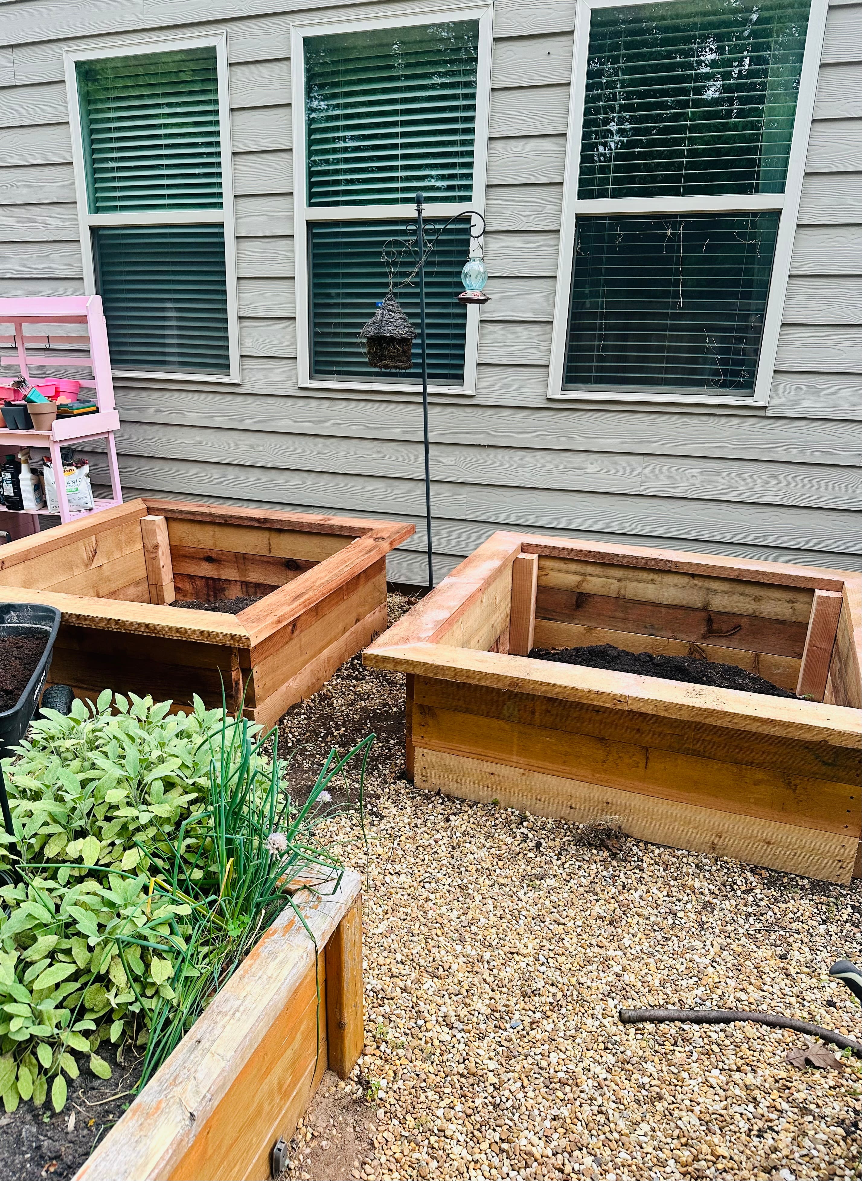 Two newly built raised garden beds in a backyard. Two newly built raised garden beds in a backyard.