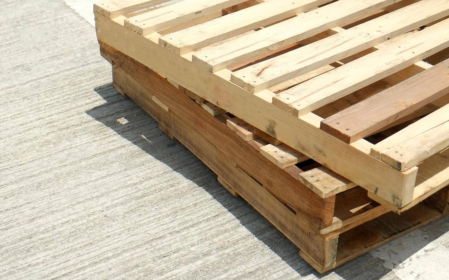 Three wooden pallets stacked on top of each other.