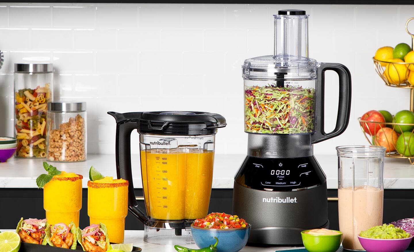 A food processor with accessories on a kitchen counter