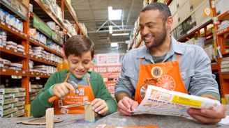 Kid and adult creating a project from a Home Depot Kids Workshop