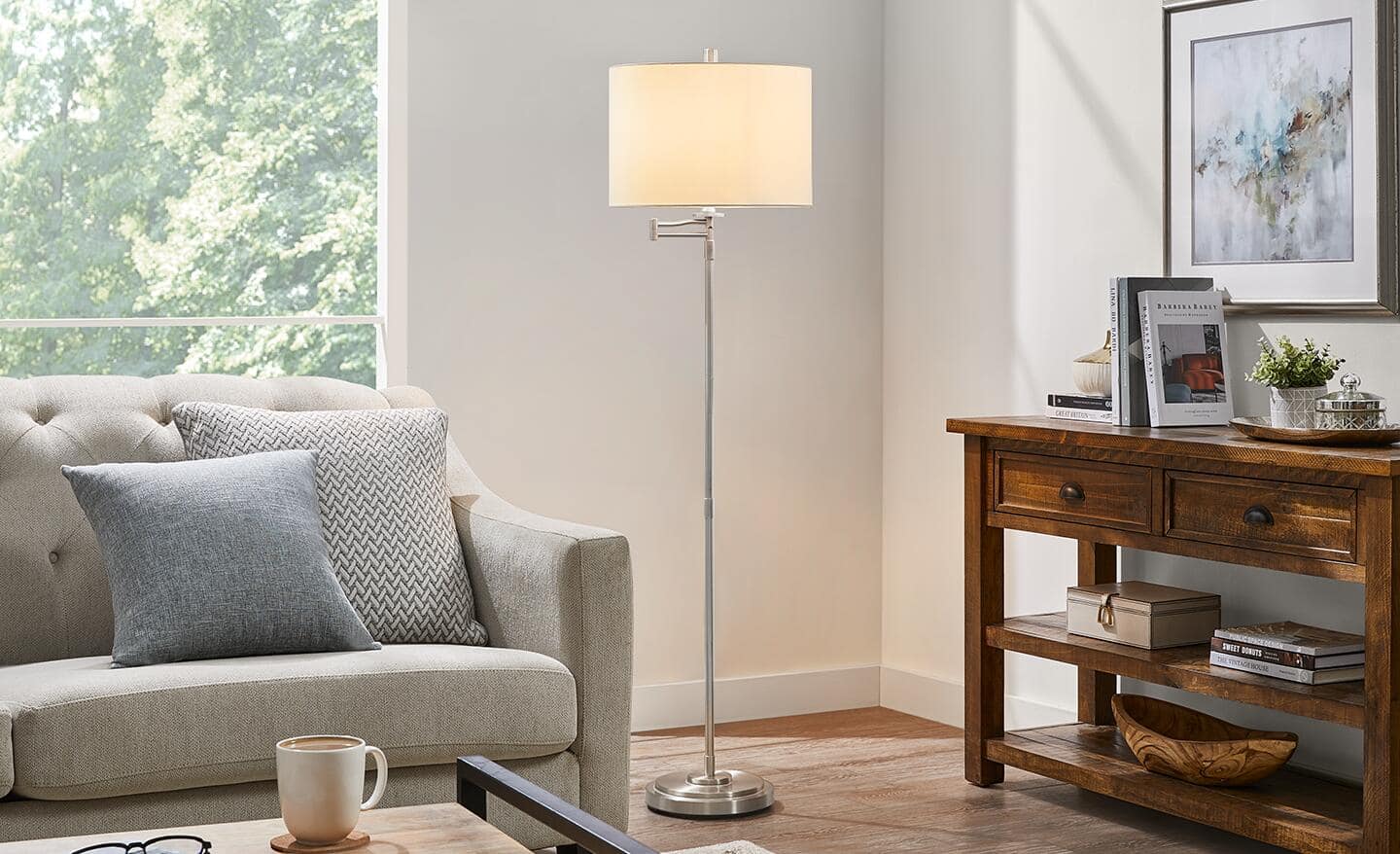 A swing-arm floor lamp illuminates a living room.