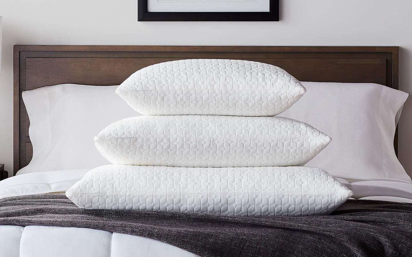 Different sized bed pillows stacked on one another. Different sized bed pillows stacked on one another.