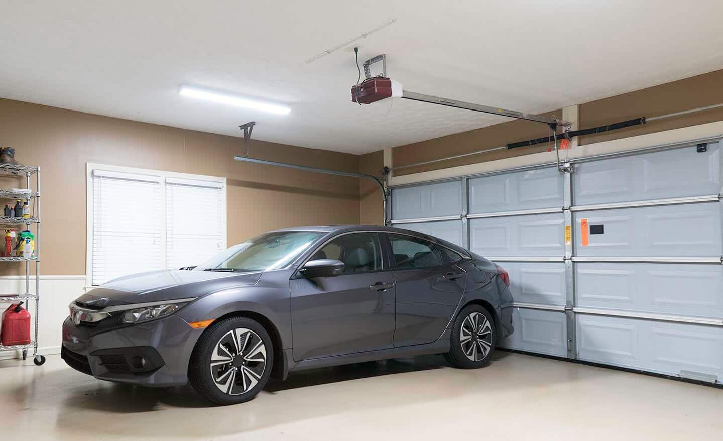 A car parked in a double garage. A car parked in a double garage.