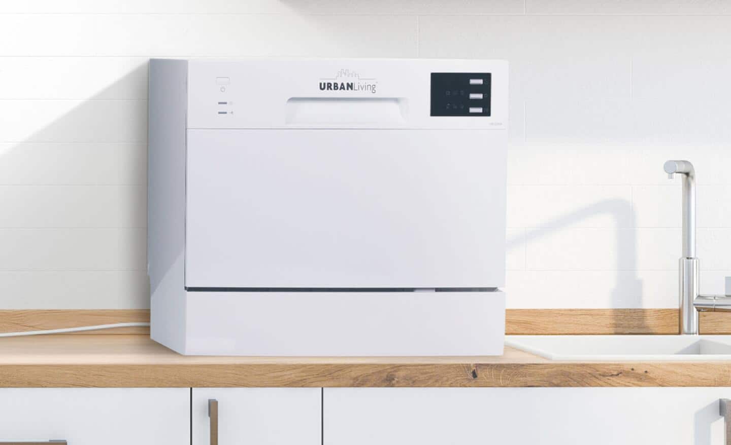 A countertop dishwasher located next to a kitchen sink.
