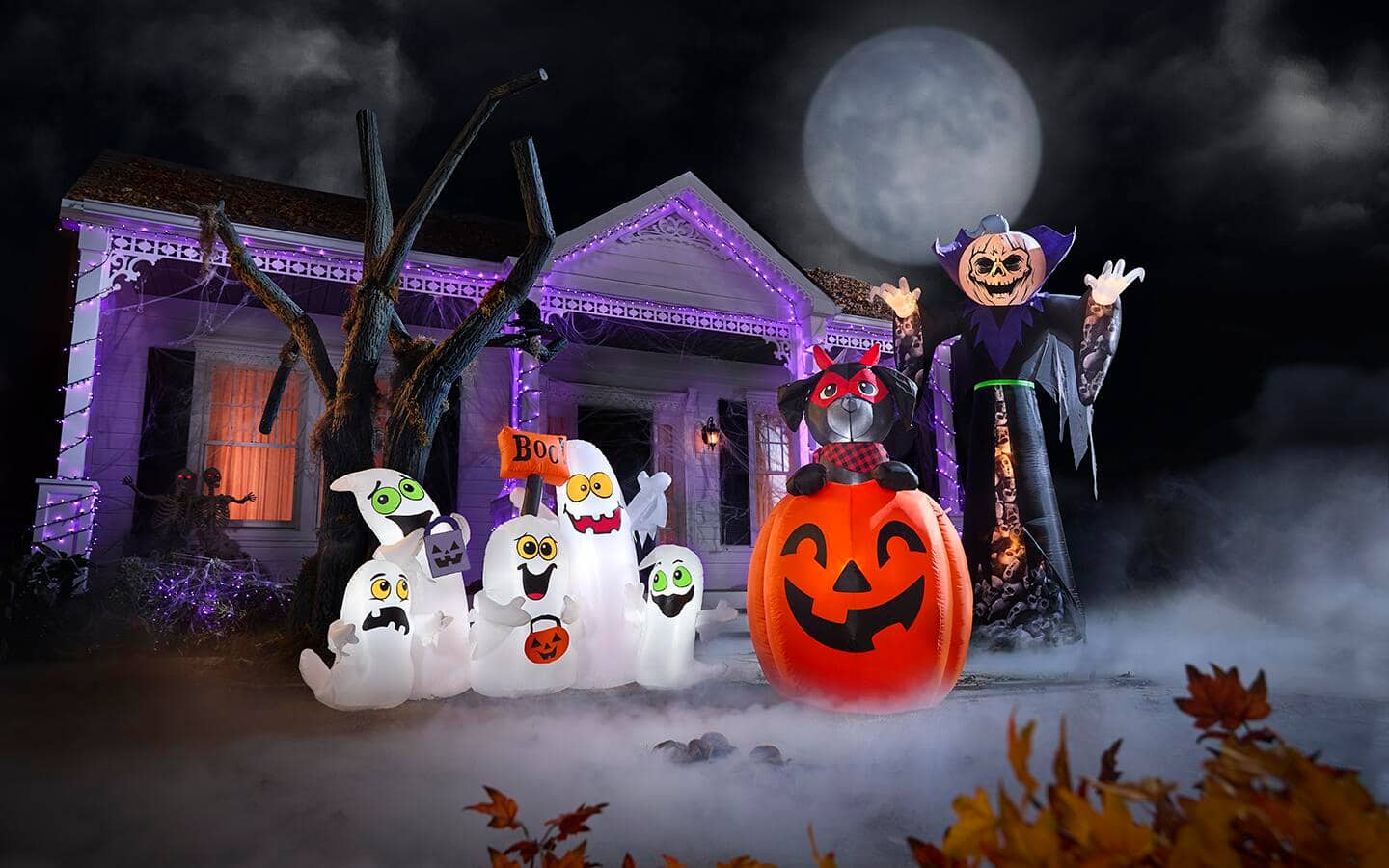 A ghostly scene featuring assorted Halloween inflatables including a Jack-o'-lantern, ghosts and a whimsical vampire.