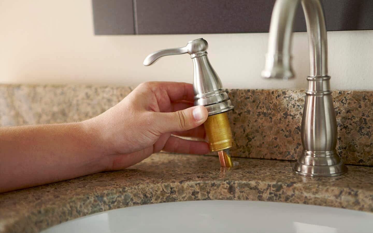 Person removing the faucet valve. Person removing the faucet valve.