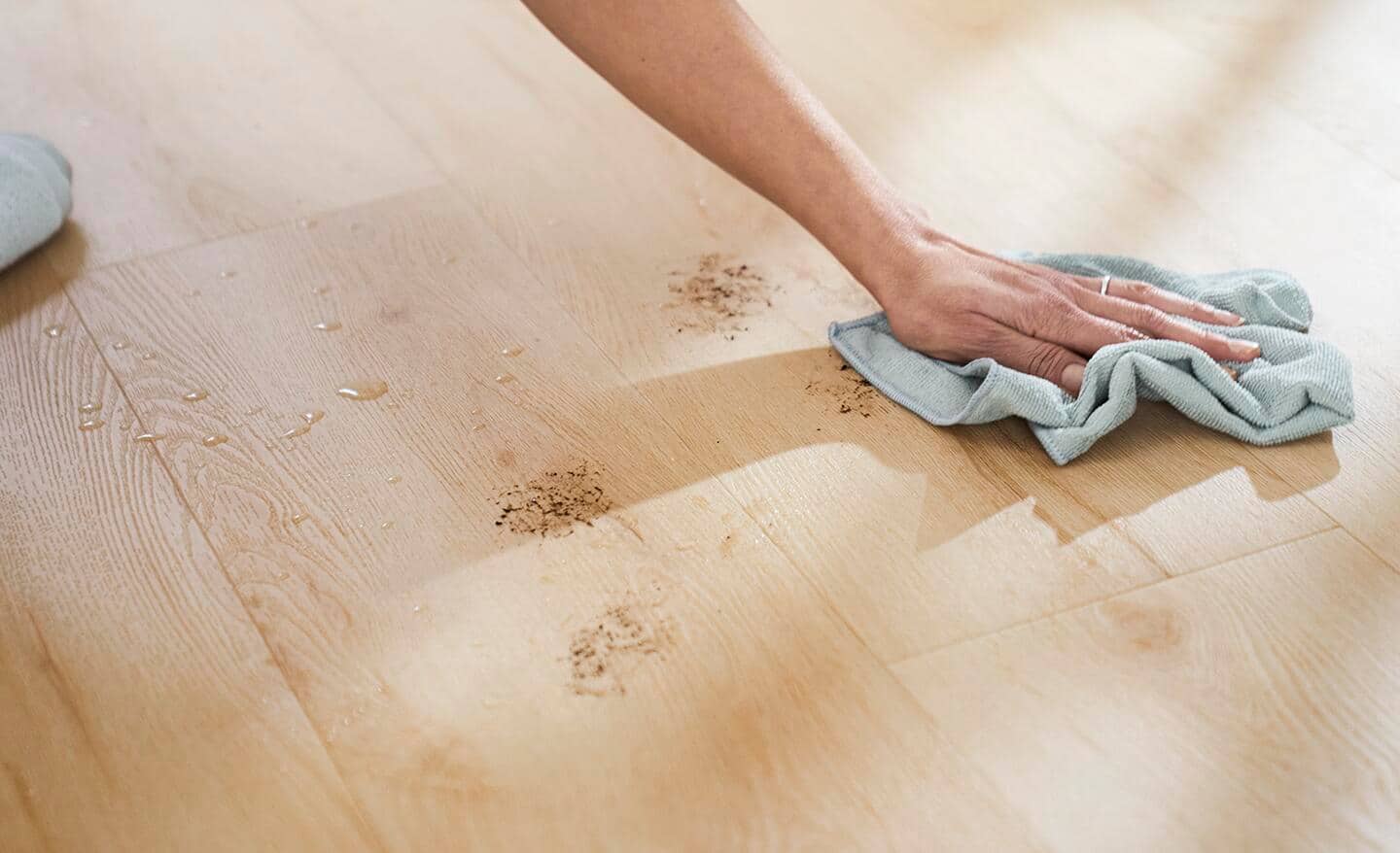 A person cleans up paw marks with a cloth.