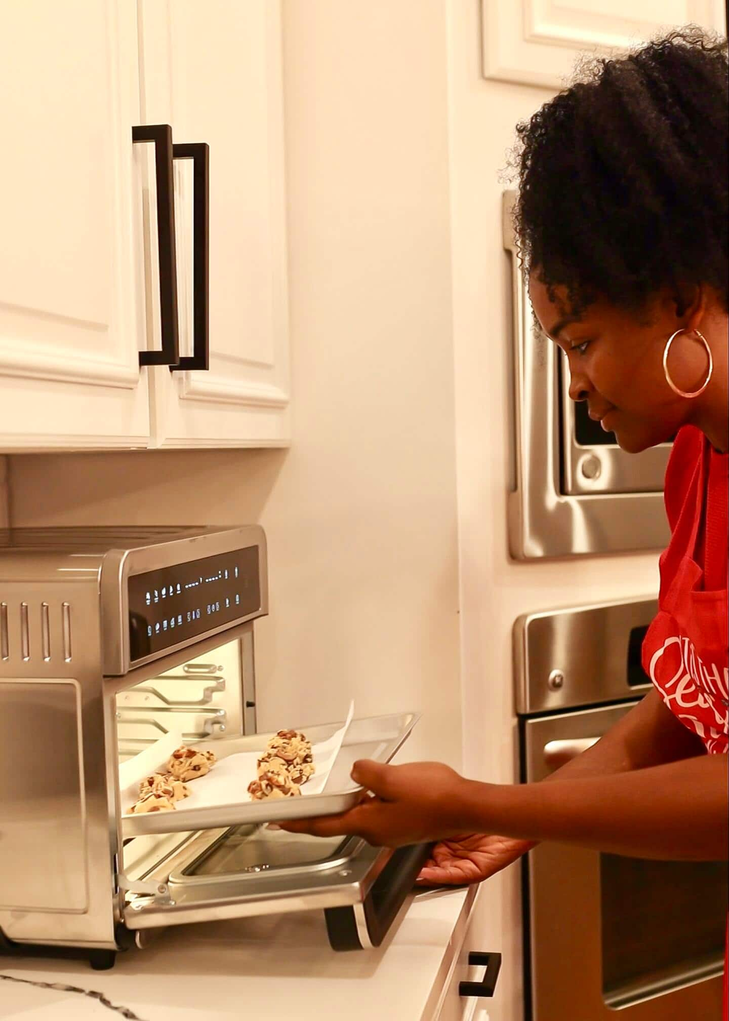 A person using an air fryer toaster oven