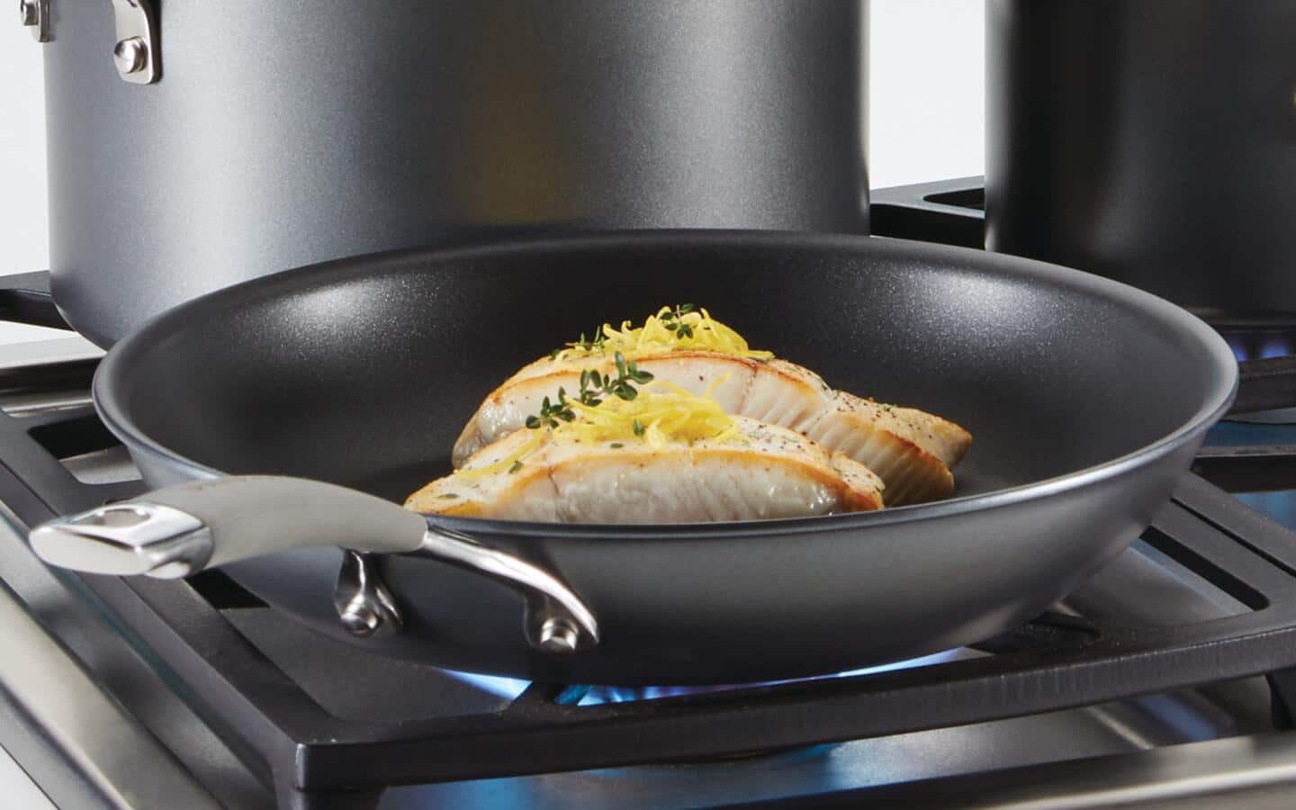 Empanadas being cooked in a non-stick wok on a stove top. Empanadas being cooked in a non-stick wok on a stove top.